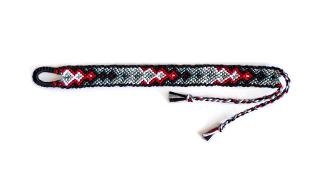 Multicolored woven DIY friendship bracelets handmade of embroidery bright thread with knots isolated on white background