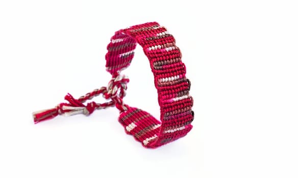 Multicolored woven DIY friendship bracelets handmade of embroidery bright thread with knots isolated on white background
