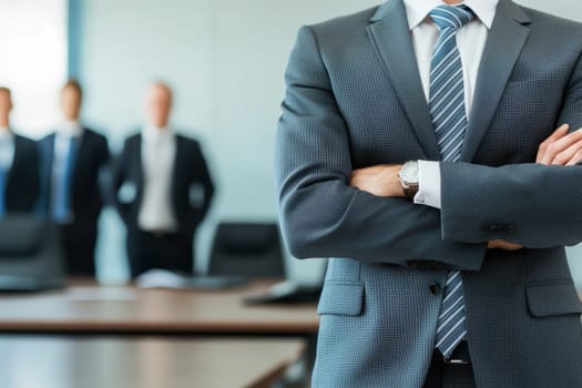 A man in a suit stands in front of three other men in suits. He is wearing a blue tie and has his arms crossed. Concept of professionalism and formality, as the men are dressed in business attire