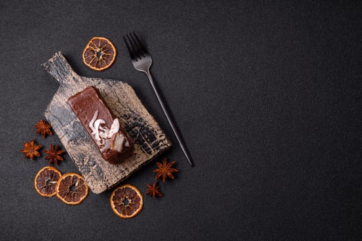 Piece of sweet chocolate bounty cake with coconut flakes and sponge cake on dark concrete background