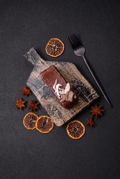 Piece of sweet chocolate bounty cake with coconut flakes and sponge cake on dark concrete background