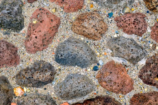 Background made of gray,brown and dark brown big stones with sand between them