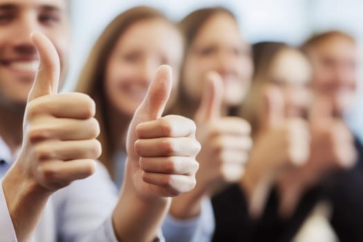 A close-up view of a group of people in an office setting proudly showing their thumbs up gesture, symbolizing positivity and teamwork.