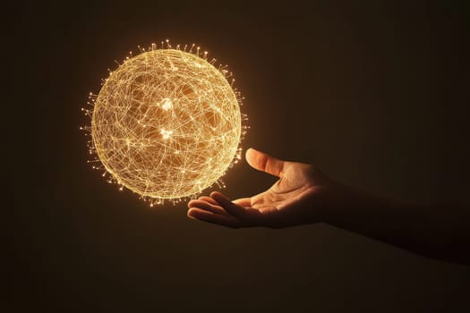 A human hand reaches out to capture a glowing sphere made of twinkling particles, symbolizing creativity and innovation against a dark background.