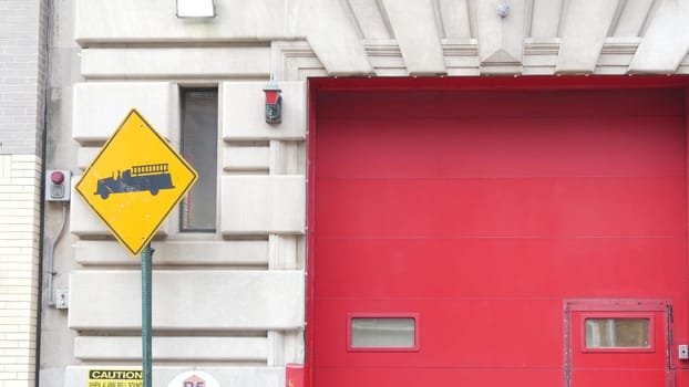 New York City, United States - 30 Aug 2023: NYFD sign, USA fire department truck, american firefighters vehicle or NYC fire fighter engine. Firemen station red gates, FD house or hall. Queens street.