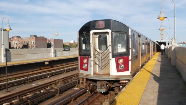 New York City, United States - 2 Sept 2023: Subway station. Metro train on public transportation platform. Elevated outdoor railway, 7 line in Queens. NYC passenger railroad traffic, Long Island City.