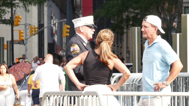 New York City, United States - 11 September 2023: Firefighters celebrate Patriot Day. FDNY officer near 911 Memorial Pools. Fire department old fireman talking to people on Manhattan Downtown, USA.