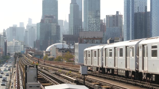 New York City, United States - 2 Sept 2023: Subway station. Metro train public transportation platform. Elevated outdoor railway, 7 line, Queens passenger railroad traffic. Manhattan cityscape skyline
