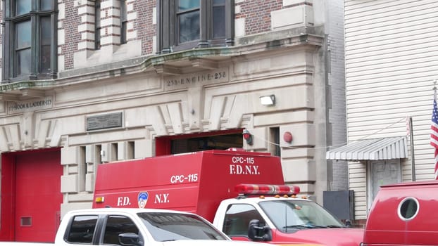 New York City, United States - 30 Aug 2023: NYFD car, USA fire department truck, american firefighters vehicle or fire fighter engine on NYC street. Firemen station red gates, FD house or hall. Queens