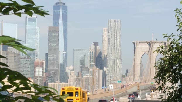 New York City, United States - 3 Sept 2023: Cars on Brooklyn Bridge from Manhattan downtown. Financial district skyline cityscape. Road traffic, people, architecture. World Trade Center skyscraper.