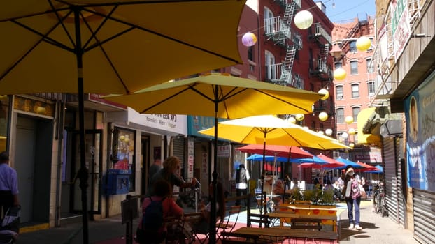 New York City, United States - 14 Sept 2023: Manhattan Chinatown Doyers street, chinese ethnic district building architecture. People, festive paper lanterns, street food umbrellas. Tourist landmark.