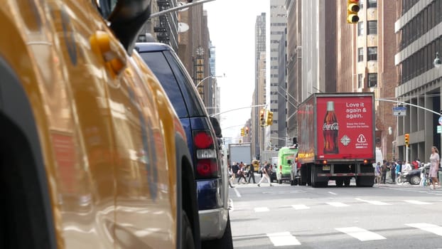 New York City, United States - 11 Sept 2023: Yellow taxi car on Manhattan street. Taxi cab on Midtown Lexington Lex avenue. Medallion taxicab. Urban road scene. Coca-Cola red truck, Cola or Coke, USA.