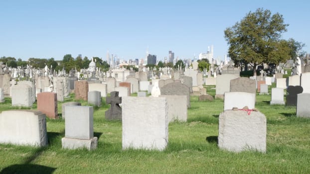 New York City, United States - 14 Sept 2023: Calvary cemetery in Queens, USA. Manhattan Midtown urban skyline cityscape architecture. Tombstones on graves, huge graveyard. Large cemetry grass lawn.