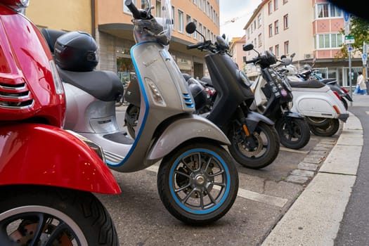 Wurzburg, Germany – September 25, 2024: Scooters parked on the roadside in the city center of Wuerzburg in Germany