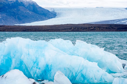 View of the melting glacier on Jokulsarlon or Jökulsárlón Glacier Lagoon, Iceland. Nature, travel, climate change, global warming, winter background, or wallpaper