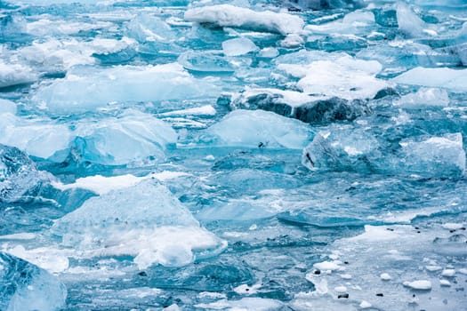 View of the melting glacier on Jokulsarlon or Jökulsárlón Glacier Lagoon, Iceland. Nature, travel, climate change, global warming, winter background, or wallpaper