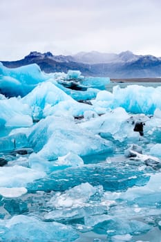 View of the melting glacier on Jokulsarlon or Jökulsárlón Glacier Lagoon, Iceland. Nature, travel, climate change, global warming, winter background, or wallpaper