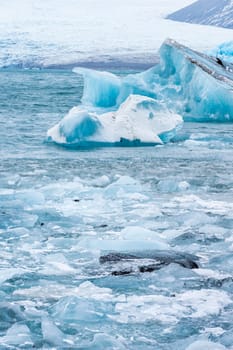 View of the melting glacier on Jokulsarlon or Jökulsárlón Glacier Lagoon, Iceland. Nature, travel, climate change, global warming, winter background, or wallpaper