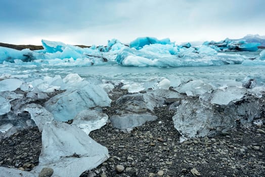View of the melting glacier on Jokulsarlon or Jökulsárlón Glacier Lagoon, Iceland. Nature, travel, climate change, global warming, winter background, or wallpaper