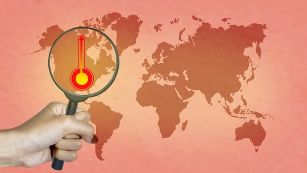 Human hand with magnifying glass looking a thermometer with a high or heat temperature indicator on the earth. Concepts of environmental protection, climate change, or global warming