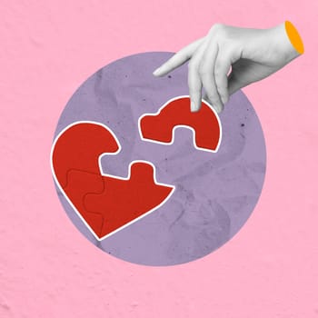 A human hand builds a puzzle of a red heart on a colored background. Concept of Valentine Day. Collage art