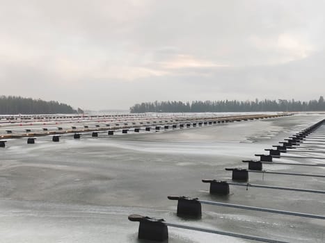 Sea marina at winter, iced Baltic sea, empty frozen harbor , winter season in Finland, marina Suomenoja, Finnoo, Northern country, cold conditions