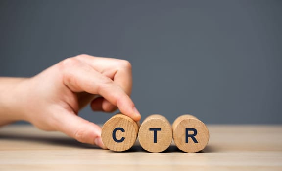 Wooden blocks with the word CTR - click through rate. Used to measure the effectiveness of marketing campaigns. Business management and analysis concept