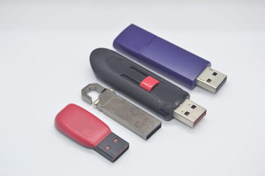 Flash drives, many shapes, old condition, placed on a white background.