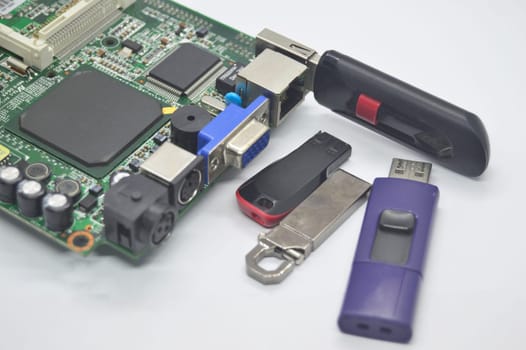 Flash drives, many shapes, old condition, placed on a white background and Plug into the motherboard, into the USB connector.