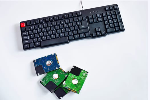 2.5-inch hard drive, swivel plate and keyboard keys on a white background