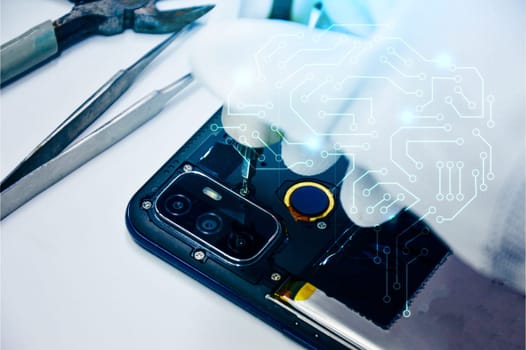 Image of a technician screwing the back of a mobile phone.