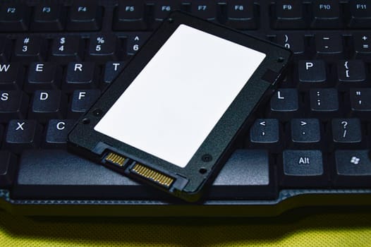2.5-inch SSD hard drive placed on the keyboard