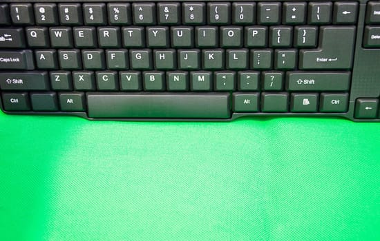 front view of keyboard keys placed on a green background