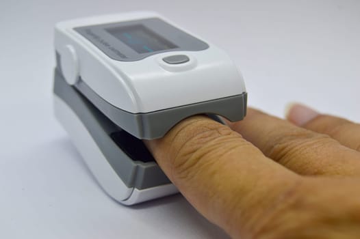 Image while using the blood oxygen monitor and heart rate monitor, the device that should be attached. in the treatment of covid 19