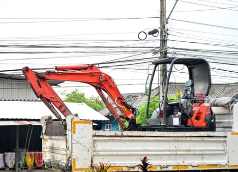 Image of moving the excavator using a truck