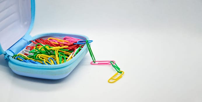 Colorful paperclips in blue pockets