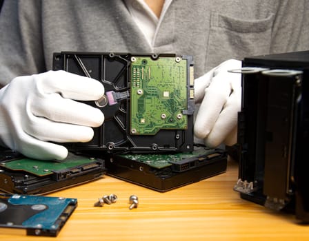 3.5 inch hard drive is still popular today, technician holding hard drive in hand