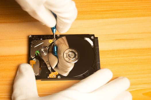 Top view of mechanic repairing hard drive