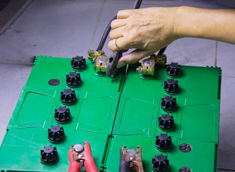 electrician connecting battery terminals