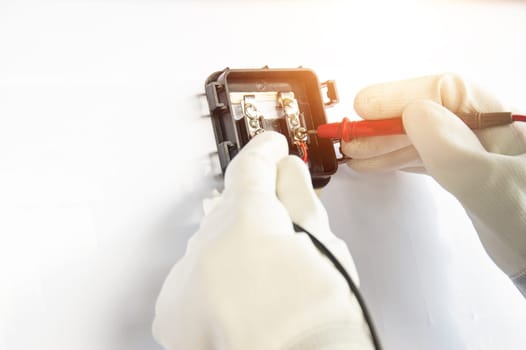 Technicians are connecting wires to solar panels.