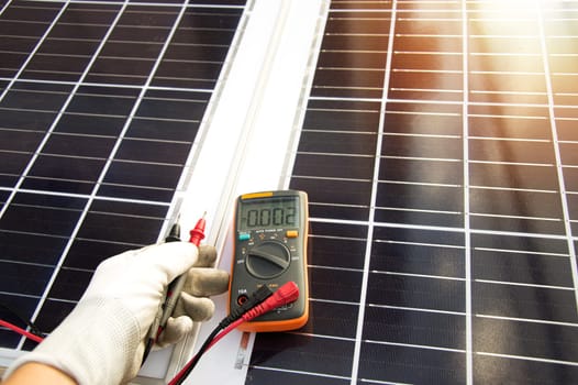 Technician inspecting solar panel installation