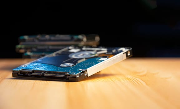 Close-up side view of hard disk on wooden floor