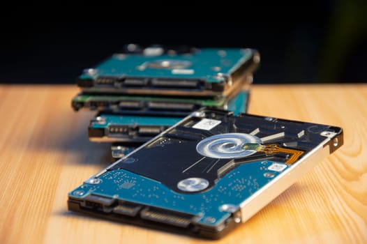 Close-up side view of hard disk on wooden floor