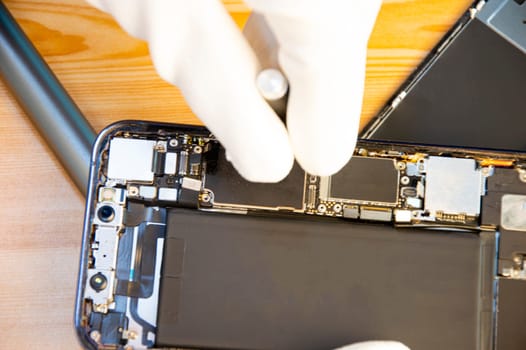 Top view of a technician repairing a smartphone