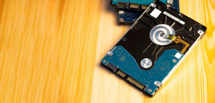 Close-up side view of hard disk on wooden floor