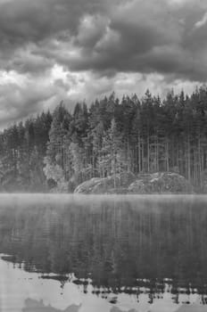 Sunrise with fog forming over a lake in Sweden, at dawn. Romantic silence, in the Scandinavian nature