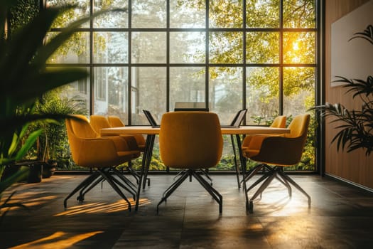 A large, yellow table with six chairs around it is in a room with a large window. The room is filled with plants and has a modern, clean look. The table is set for a meeting or gathering