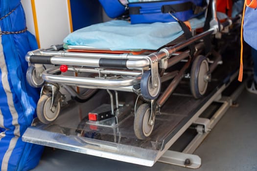 Close-up view of a folded stretcher in the interior of an ambulance, highlighting the medical readiness for emergencies