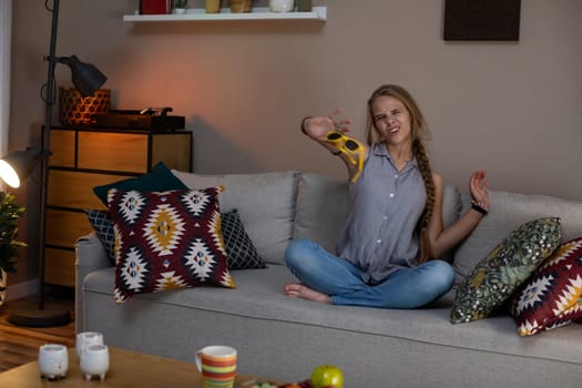 A woman is sitting back comfortably on a cozy couch, happily enjoying the warm ambiance of her lovely living room