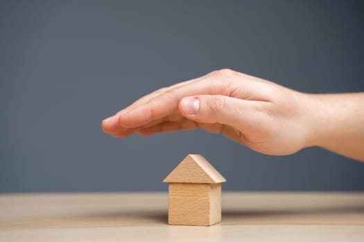 Insurance agent protects the house with a gesture of protection. The concept of property insurance protection and housing. Security and safety in the home. Life insurance and family. Real estate